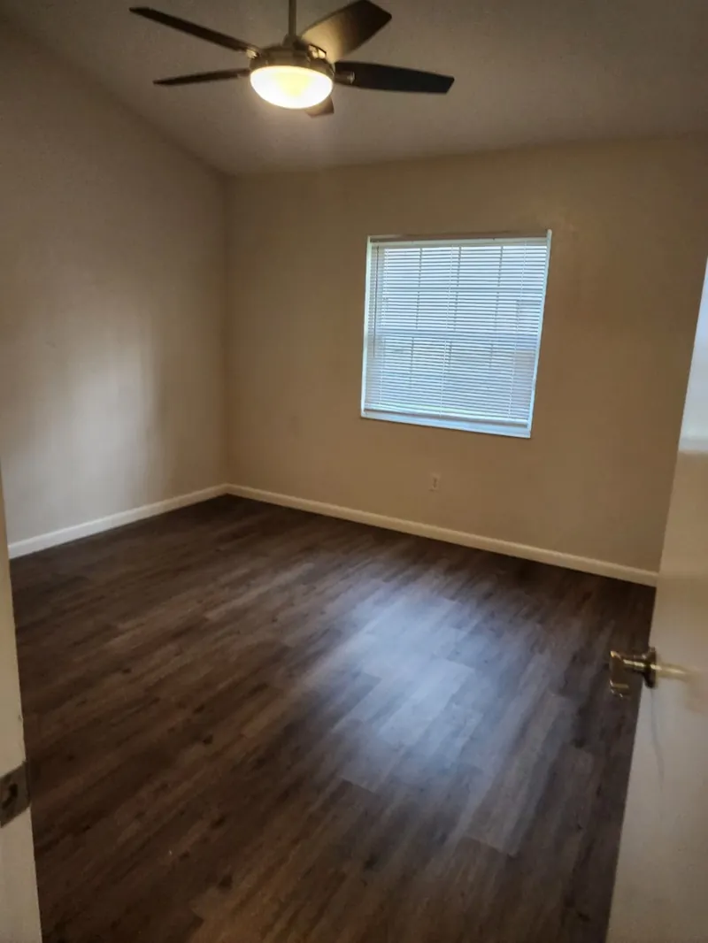 Empty bedroom with clean floors after a move-out cleaning
